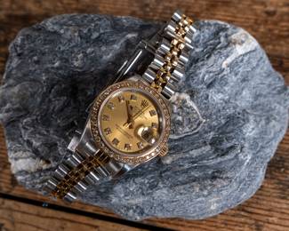 An Oyster Perpetual Datejust lady's bracelet watch. With an 18k yellow gold and diamond bezel, synthetic sapphire crystal, and a Rolex Oyster Perpetual certified chronometer automatic movement with date. Fitted with a stainless steel and 18k yellow gold Jubilee bracelet. Total weight 53.52 grams. Comes with official assessment paperwork from Pacific Gemological Laboratory INC.
