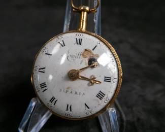 An 18K gold pocket watch with an enamel face and both Roman and Arabic numerals, and an artistic enamel back. Made by watchmaker Jean Romilly circa 1780-1790. The face and back of the movement are both inscribed "Romilly A PARIS"