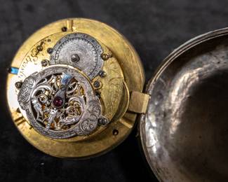 A silver pocket watch with an enamel face and Arabic numerals. The back movement has a center jewel. Made by watchmaker Franz Georg Rothea of Strasbourg, France. Rothea was active making watches between 1737-1742. This watch is missing it's glass dome and has no key.