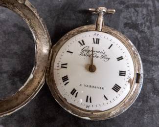 A silver pocket watch and silver case with an enamel face and Roman numerals. Made by watchmaker Gugenmus Horloger Du Roy of Warsaw, Poland. Circa 1790's. The face and back of the movement are both marked with the makers name. The back of the movement had a unique glass cover. The interior hinge is missing the pin and the outer glass cover is loose.