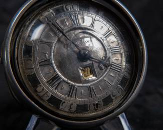 A silver pocket watch held in a silver case, made by Will Kipling of London. Circa 1720's. A silver face with Roman and Arabic numerals and a date counter. Engraving "K0266". Inside is marked "TN" and "1065". 1065 is also marked on the watch mechanism and is believed to be the pieces serial number. No key.