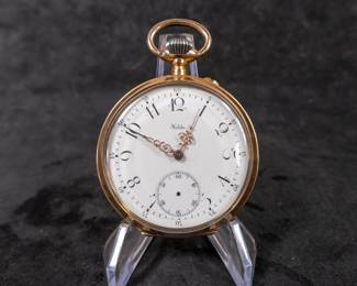 An 18k gold wind-up mechanism pocket watch with an enamel face and Arabic numerals. Made by Halda Fickurfabrik of Sweden. Early 1900's.
