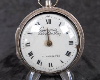 A silver pocket watch and silver case with an enamel face and Roman numerals. Made by watchmaker Gugenmus Horloger Du Roy of Warsaw, Poland. Circa 1790's. The face and back of the movement are both marked with the makers name. The back of the movement had a unique glass cover. The interior hinge is missing the pin and the outer glass cover is loose.
