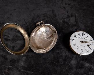 A silver pocket watch in a silver case with an enamel face and Arabic numerals, made by watchmaker John Ward of London, Late 18th Century. The movement on the back is signed "John Ward Fore Street London" Number 2690. The back movements shows a monogram of King George III, with two "G"s one reversed, and the Roman numerals III with a crown affixed on top. This watch is missing it's glass cover, and has a damaged hinge and watch hand.