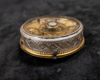 A silver pocket watch and silver case with an enamel face and Roman numerals. Made by watchmaker Gugenmus Horloger Du Roy of Warsaw, Poland. Circa 1790's. The face and back of the movement are both marked with the makers name. The back of the movement had a unique glass cover. The interior hinge is missing the pin and the outer glass cover is loose.