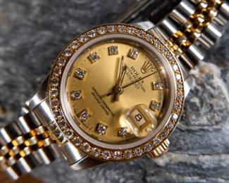 An Oyster Perpetual Datejust lady's bracelet watch. With an 18k yellow gold and diamond bezel, synthetic sapphire crystal, and a Rolex Oyster Perpetual certified chronometer automatic movement with date. Fitted with a stainless steel and 18k yellow gold Jubilee bracelet. Total weight 53.52 grams. Comes with official assessment paperwork from Pacific Gemological Laboratory INC.