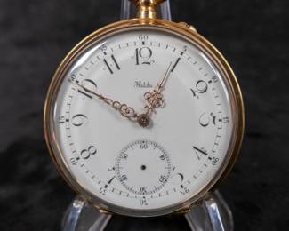 An 18k gold wind-up mechanism pocket watch with an enamel face and Arabic numerals. Made by Halda Fickurfabrik of Sweden. Early 1900's.