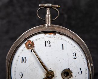 A silver pocket watch with an enamel face and Arabic numerals. The back movement has a center jewel. Made by watchmaker Franz Georg Rothea of Strasbourg, France. Rothea was active making watches between 1737-1742. This watch is missing it's glass dome and has no key.