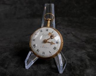 An 18K gold pocket watch with an enamel face and both Roman and Arabic numerals, and an artistic enamel back. Made by watchmaker Jean Romilly circa 1780-1790. The face and back of the movement are both inscribed "Romilly A PARIS"