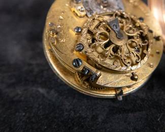 An 18K gold pocket watch with an enamel face and both Roman and Arabic numerals, and an artistic enamel back. Made by watchmaker Jean Romilly circa 1780-1790. The face and back of the movement are both inscribed "Romilly A PARIS"