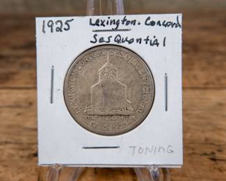 A 1925 50C Lexington-Concord Sesquicentennial commemorative half-dollar. Nice toning with an estimated AU condition.