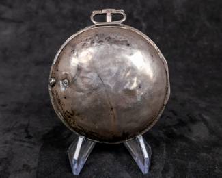A silver pocket watch in a silver case with an enamel face and Arabic numerals, made by watchmaker John Ward of London, Late 18th Century. The movement on the back is signed "John Ward Fore Street London" Number 2690. The back movements shows a monogram of King George III, with two "G"s one reversed, and the Roman numerals III with a crown affixed on top. This watch is missing it's glass cover, and has a damaged hinge and watch hand.