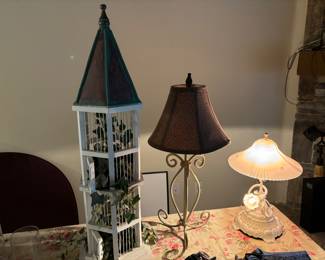Lamps, vintage birdhouse,  tall candle sticks, candles, tea lights, Christmas balls, Christmas skirt. 