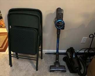 Vacuums and folding chairs. Iron frame holder. 