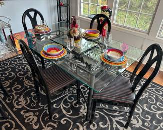 Glass top dining table, colorful dish set, stemware 