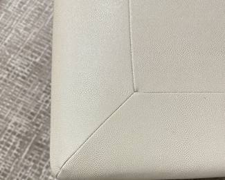 Baker Furniture Cocktail Table Upholstered In Textured Cream Faux Leather Fabric and Finished with Nailhead Trim. Measures 26" x 36" x 18.5" H. Photo 3 of 4.