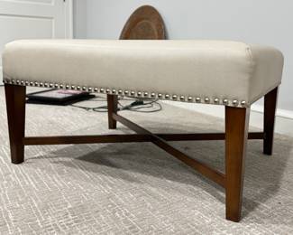 Baker Furniture Cocktail Table Upholstered In Textured Cream Faux Leather Fabric and Finished with Nailhead Trim. Measures 26" x 36" x 18.5" H. Photo 1 of 4.