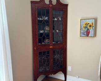 T9 - $395 - Antique Corner Cabinet. Measures 36" across the front. 26.5" out from each corner. 91" tall. Very good antique condition except 2 panels of glass that are cracked. Both are in the bottom left corner. The rest of the glass is wavy. 