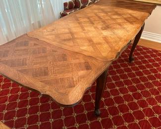 T21 - $325. Expandable French Table with Parquet Top. Measures 35" wide x 54.5" long x 30" tall. Each leaf adds 20". Top has signs of use - maybe sun fading? Structurally sound!