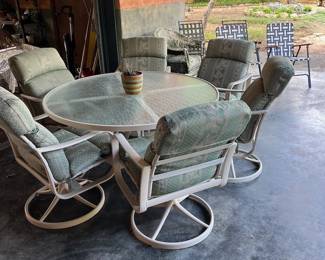 glass patio table with upholstered chairs