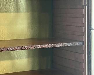 Carved English ribbon and daisy trim on the shelves