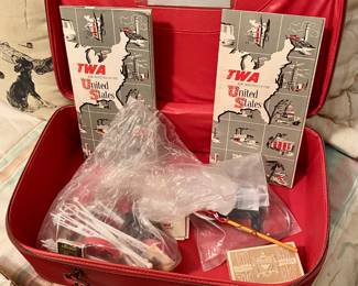 From the 1950's Pilot in the family, an American Tourister Red Luggage piece with TWA Airlines insignia on top and TWA collectibles inside.