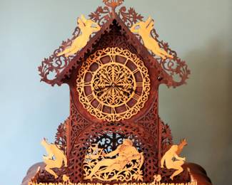 A late 19th century Victorian Period Fretwork mantel clock. Waterbury 8-day time and strike with fretwork movement with wooden dial and Roman numerals. Walnut scroll case with Neoclassical design and Satinwood Greek figures. Older finish with some wear, several repairs, minor damage and losses to case, lacks pendulum. 19 1/4 x 5 3/4 x 24" high overall. ESTIMATE $50-75 NOTE: This lot picks up from the home in Coldwater, Michigan.