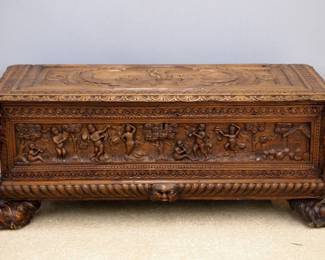 A late 18th century Baroque style blanket chest. Oak construction with extensive hand carved decoration on top, front and side panels depicting Cherubs with full figural corner posts and carved mask feet. Older finish with minor wear, top with reinforcement strips at underside. 52 x 21 x 21" high overall. ESTIMATE $1,000-1,500 NOTE: This lot picks up from our Ypsilanti, Michigan facility.