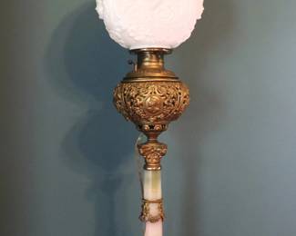 A 19th century Victorian Period banquet lamp. Molded Milk Glass shade over a pierced Gilded Bronze font with Onyx stem and plinth base with cast feet. Electrified, Bronze fittings re-patinated, chips and edge flakes to Onyx. 10 1/2 x 10 1/2 x 33 1/2" high overall. ESTIMATE $200-300 NOTE: This lot picks up from the home in Coldwater, Michigan.
