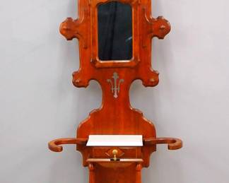 A 19th century Victorian Eastlake Period hall tree. Walnut construction with Burl detail features a shaped upper section with turned coat pegs around a central mirror, lower glove drawer with molded marble top and a base with umbrella holders and cast iron drip pans. Refinished with slight wear. 37 x 12 x 89 1/2" high overall. NOTE: This lot picks up from our Ypsilanti, Michigan facility.
