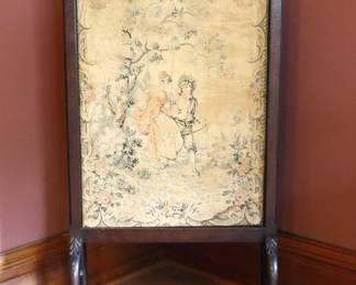 A 19th century Victorian Period fire screen. Carved Mahogany frame with flame finials and Romantic style needlepoint panel at front and later floral embroidery at back on curved legs with carved paw feet. Panels replaced or reworked, Romantic needlepoint with significant fading, reverse embroidery with minor water damage at corner, frame with older finish, minor wear and scuffs, small traces of paint residue. 25 1/2 x 14 1/2 x 50 1/2" high overall. NOTE: This lot picks up from the home in Coldwater, Michigan.