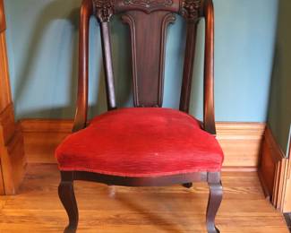 A 19th century Victorian Empire style side chair. Mahogany construction with molded crest having carved Bacchus masks over shaped splats, an upholstered seat and cabriole legs. Older refinishing with minor wear and scuffs, lacks three castors. 23 x 22 x 35 1/2" high overall. NOTE: This lot picks up from the home in Coldwater, Michigan.