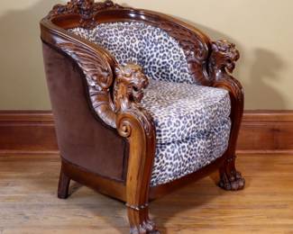 A turn of the century carved armchair, possibly by Karpen Bros. Chicago. Mahogany construction with tub form and Lion mask crest over figural Griffon arms and carved paw feet. Refinished with minor wear, right arm front with scrapes and small chip, minor damage to legs, later upholstery with some pilling. 30 1/2 x 32 x 39" high overall. ESTIMATE $300-500 NOTE: This lot picks up from the home in Coldwater, Michigan.