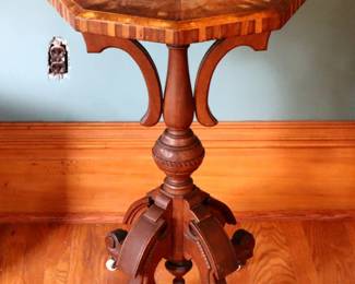 A 19th century Victorian Period lamp stand. Walnut construction with carved detail, inlaid octagonal top over a turned stem and scrolled feet. Old finish with some wear, water damage to top, shrinkage and minor damage to inlay. 17 1/2 x 17 1/2 x 28 1/2" high overall. ESTIMATE $200-400 NOTE: This lot picks up from the home in Coldwater, Michigan.