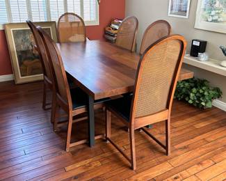 Milo Baughman tri-wood dining table with six Baughman curved cane back dining side chairs. Desined for Directional furniture gallery.