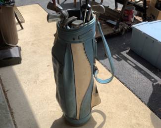 Partial set of golf clubs and bag