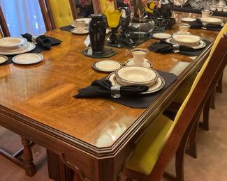 The dining table has 8 chairs, 3 leaves, and a pad.