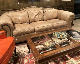 Tan leather sofa with nailhead trim
