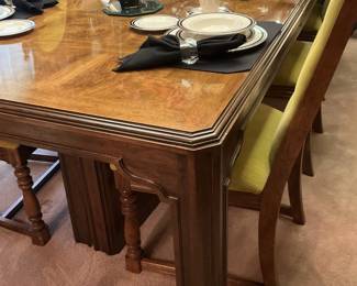 The dining table has 8 chairs, 3 leaves, and a pad.