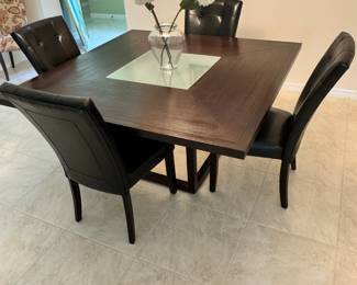 Square dining table with glass center and 4 chairs $625