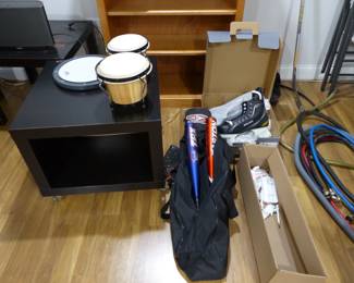 Misc basement items, bats, ice hockey skates, bongo drums
