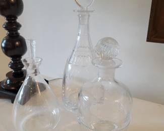 Decanters by St. Louis, Baccarat, Lalique and others.