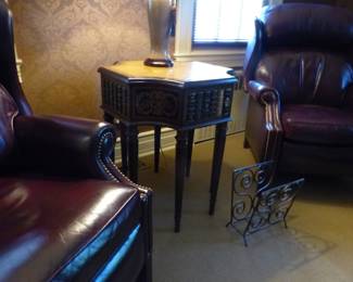 Pair of leather recliners, side table with faux books