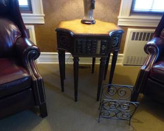 Pair of leather recliners, side table with faux books