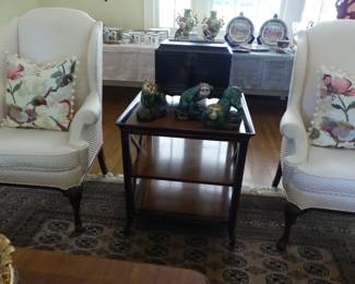 Pair of neutral wing chairs, decorative pillows, mahogany 3 tier side table, bric-a-brac