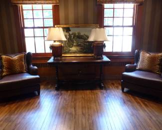 Pair of leather chairs, Library table, pair of lamps with lion's head trim, decorative art, decorative pillows