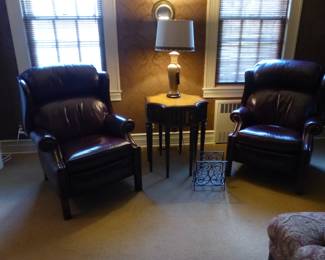 Pair of leather recliners, side table with faux books, lamp