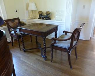Theodore Alexander game table with 2 chairs, bric-a-brac on shelf