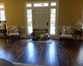 Pair of neutral accent chairs, decorative pillows, pair of petite French side tables, pair of lamps