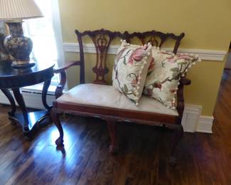 Round side table, lamp, Mahogany Chippendale style carved settee/bench, decorative pillows